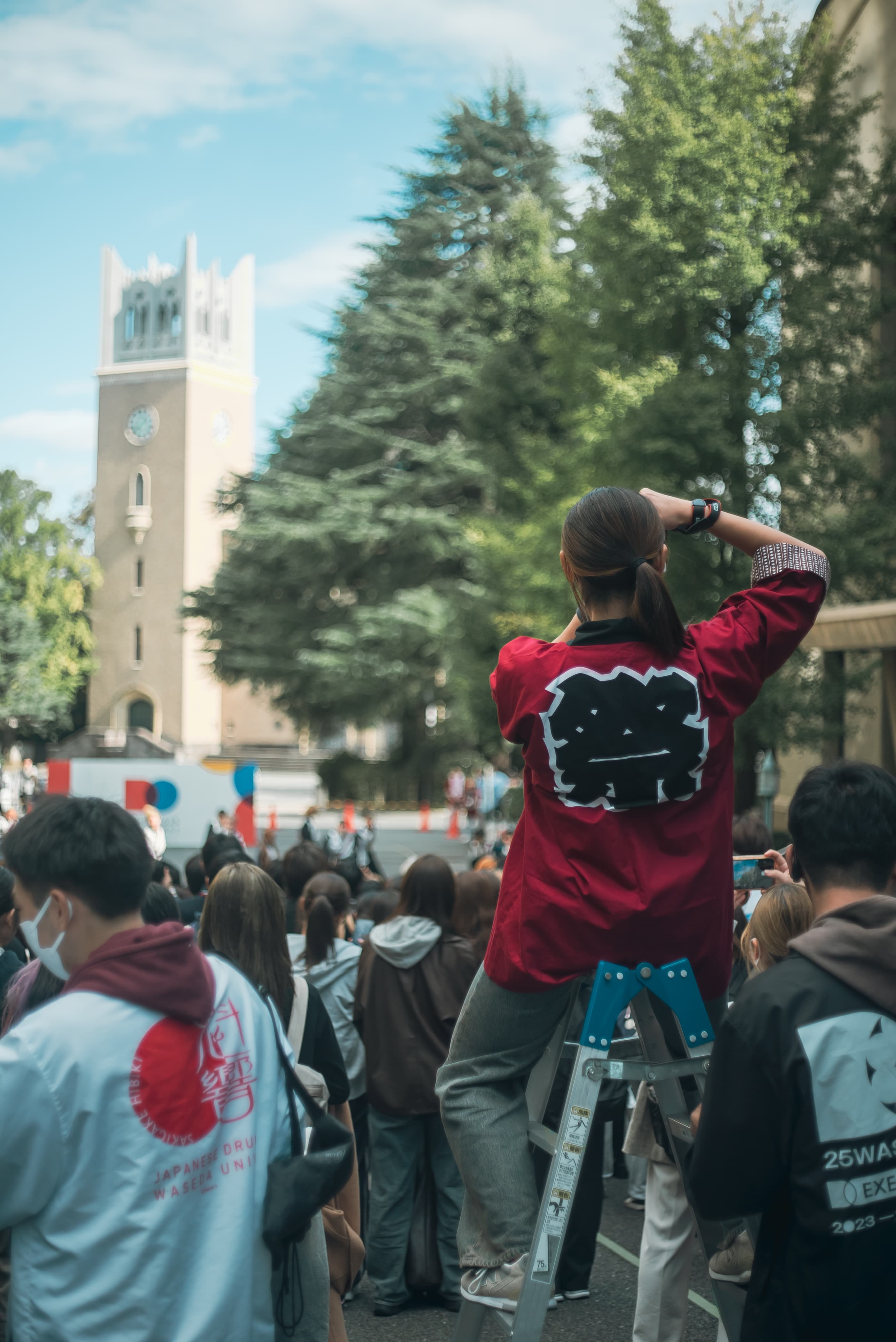 脚立に座り写真を撮る運営スタッフ